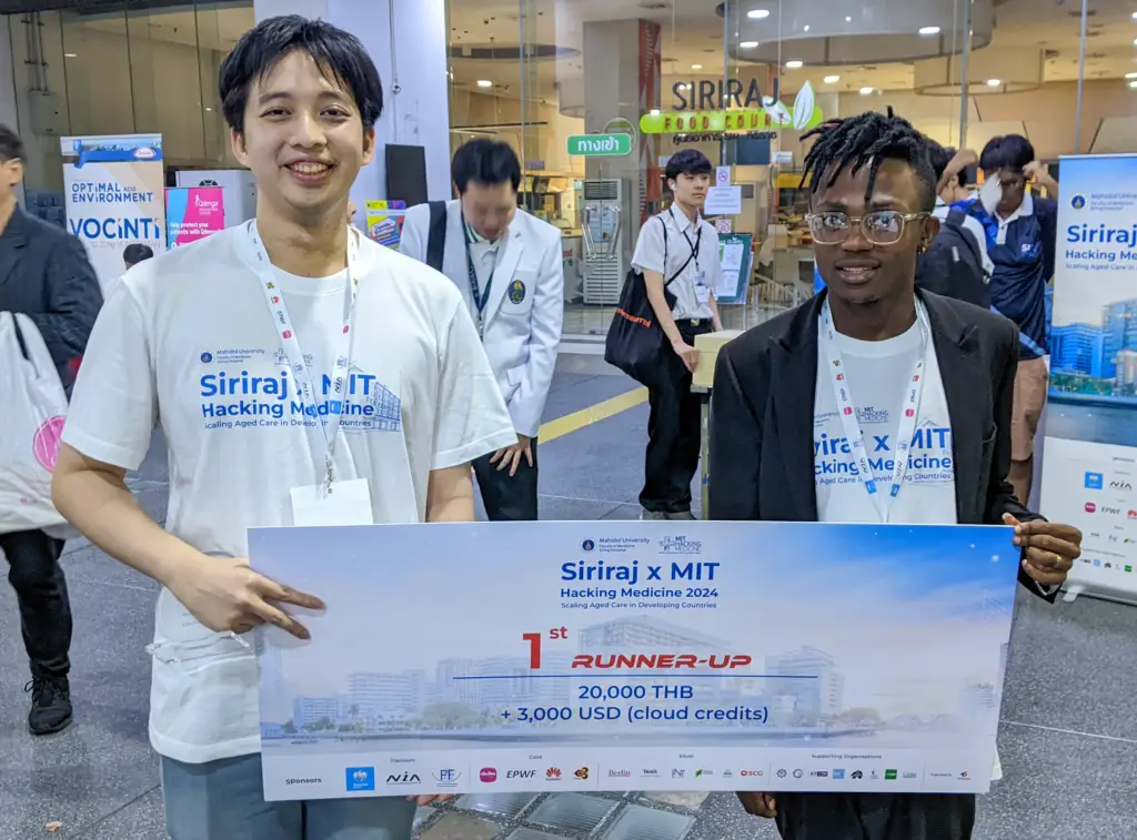 Olivier Itangishaka poses for a photo with a fellow participant after winning at the MIT hackathon in Bangkok